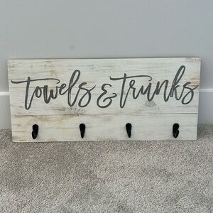 Wooden towels and trunks sign